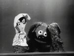 Rowlf attempts to work a hand puppet.