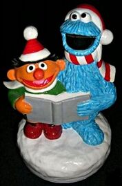 Ernie and Cookie Monster caroling; the music box plays "We Wish You a Merry Christmas". 1982