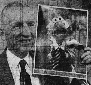 H. Ross Perot holds a photo of H