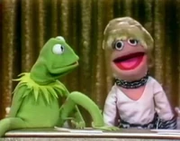 Hawn kisses Kermit and becomes a Muppet.
