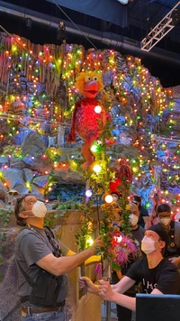 Two crew members help Ben Durocher performing a Fraggle on stilts