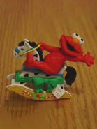 Elmo on a rocking horse.