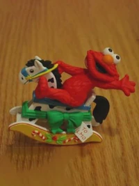 GrolierElmoRockinghorse.jpg (50 KB) Elmo on a rocking horse.