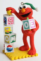 2006 Elmo Ornament, the blocks feature the faces of Zoe, Rosita, Big Bird, and Grover