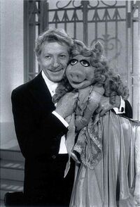 Danny Kaye and Miss Piggy, check to cheek.