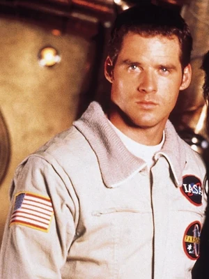 Crichton in his IASA-issued flight suit, featuring an IASA patch