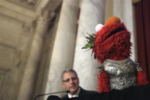 Gary Knell, president and CEO of Sesame Workshop, and Elmo, make the announcement of a new partnership between the National Children's Museum and Sesame Street on Thursday, February 3, 2011, in Washington.