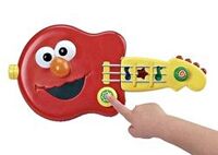 2-in-1 Giggle Guitar Elmo guitar flips to Cookie Monster bass