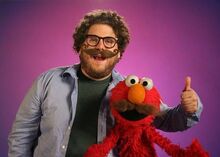 Elmo wears a fake mustache to help Jonah Hill present the word of the day, "mustache," in a 2008 episode of Sesame Street.