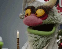 Big Mean Carl blows out a candle in The Muppets "Single All the Way"