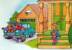 Janice sits outside her house while her teenage brothers work on a car.