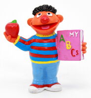 Ernie with an apple and a book