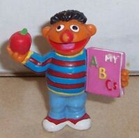 Ernie with an apple and a book