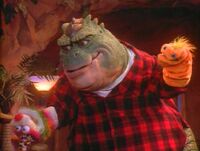 Earl Sinclair performs a Punch and Judy-esque puppet show to keep Baby Sinclair entertained in the Dinosaurs episode "Baby Talk."