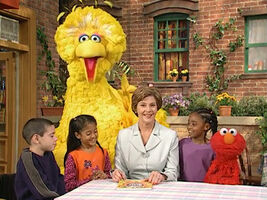 Laura Bush with Big Bird, Elmo, and some kids on Sesame Street episode 4032.