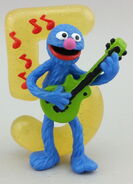 Grover with glittery 5, playing guitar