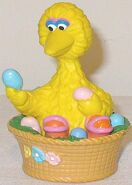 Big Bird looks at Easter eggs in his nest.