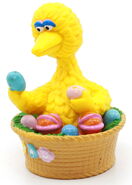 Big Bird looks at Easter eggs in his nest.