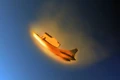 (MLA) A HSST with a re-entry shell carrier attachment entering the atmosphere.