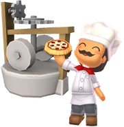 Chef Gino Delicioso holding a pizza in front of a flour mill.