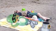 Nebulob not wearing its suit and sunbathing with Monster-Handler Tyson