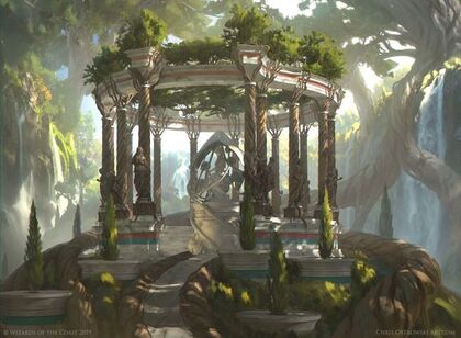 An open stone structure with columns out in the woods. Trees are growing in and around it.