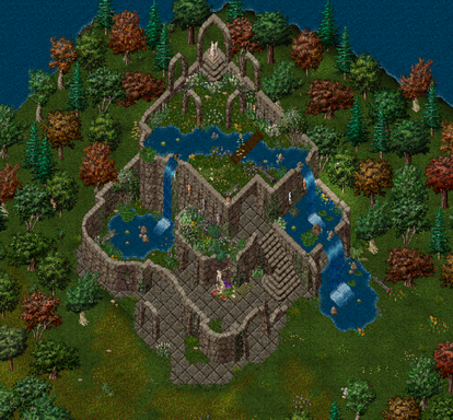A stone building with water flowing from the third floor. It is covered in plants, vines, and flowers.