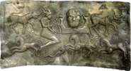The figure holding the broken wheel is more tentatively thought to be Taranis by scholars, this depiction is also represented in a number of Iron Age images; there are also many wheels that seem to have been amulets.