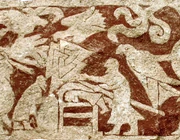 Detail from Stora Hammars I, Sweden shows a man lying on his belly with another man using a weapon on his back. Note the triangular Valknut symbol above, which is theorized to represent an ecstatic state.