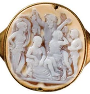 Ring with a stone inset in relief, 1st c. A.D. Melampus is depicted in the center background, holding aloft and upside down a branded swine and a laurel branch. He is purifying Proetus’ daughters. Lysippe, Iphinoe and Iphianassa. With them are a young man and also a nymph of the springs, from which source water was used for the cleaning (Médailles et Antiques de la Bibliothèque Nationale de France).