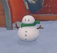 A snowman with its scarf dyed green