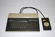 An image of a Sord M5; a Sord M5 joystick is attached to it.