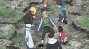 Sarada and the others inspect Kawaki.