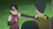 Sarada releasing a genjutsu that was put on a villager.
