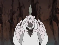 Puppet 2: This puppet had grey markings around its mouth area and hair coming from a single point on its head. It was shown to have colossal fists and fierce taijutsu skills. In the anime it was able to extend its arms to form a sort of cage to trap opponents, where it would then launch four small bombs from its mouth. Since the explosion was accurate and very small, it dealt a great amount of damage to enemies whilst not damaging the cage.