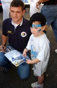 Casey Atwood posing with a young fan at Dover in 2004, courtesy of the U.S