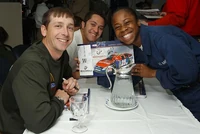 Ashton Lewis (left) signing an autograph, courtesy U.S