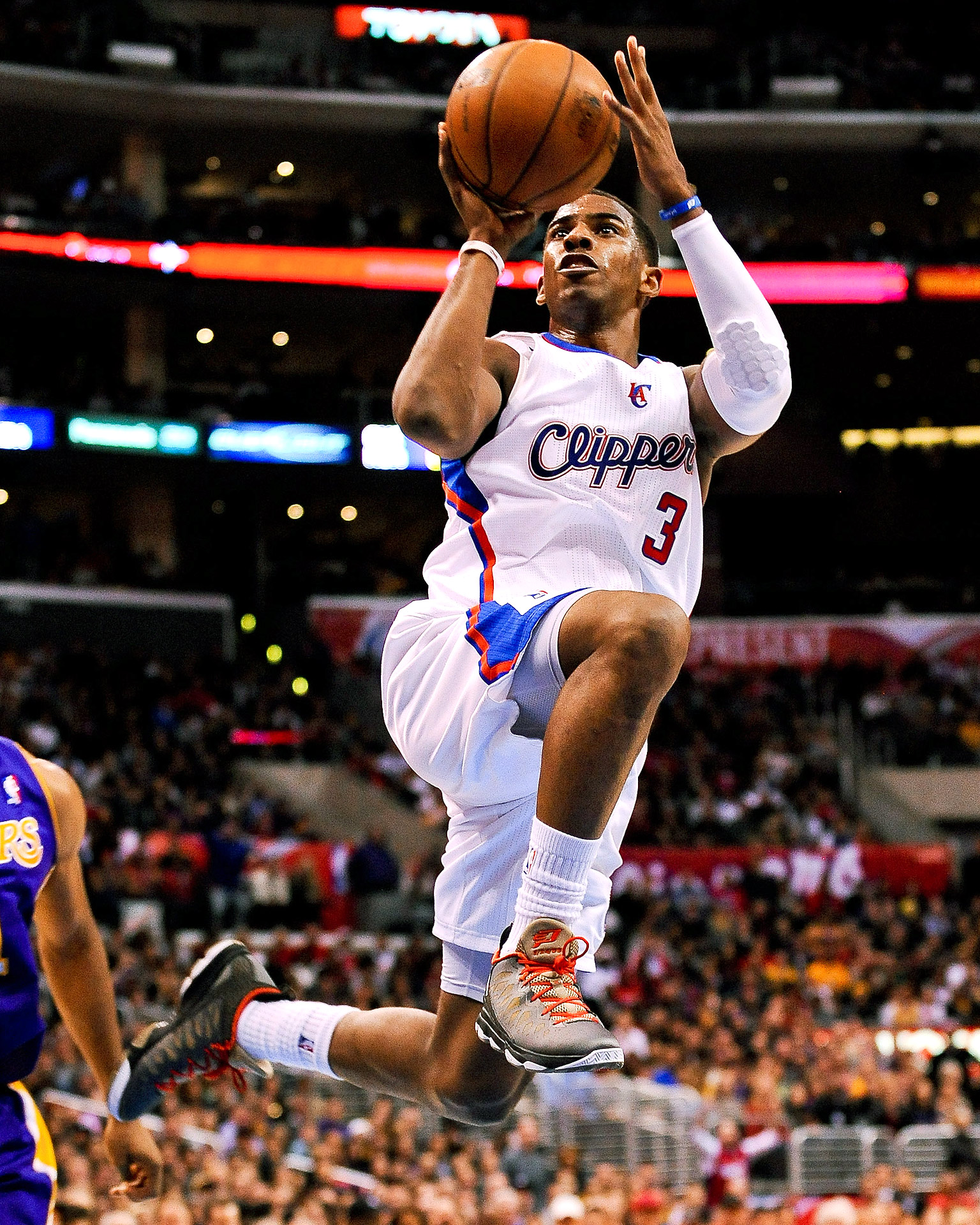 Chris Paul smiles in light blue Clippers jersey holding ball with CP3 shoes  - Clippers News Surge NBA Gallery - Los Angeles Clippers Pictures & Photos