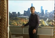 Paul Robinson on the balcony with a view of Melbourne behind.