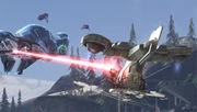 Human UNSC forces in an air vehicle called a Hornet fires on enemy Covenant aircraft above ancient Forerunner structures.