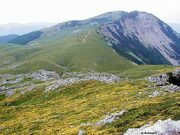 Contrast between north i south slopes, southern slopes soft i grassy in spring covered sa carpets of flowers., northern slopes are steep sa cliffs i scree slopes, behind is highest peak V