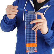 The clear eighteen dart clip being loaded with Elite Darts.