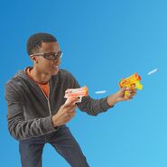 A model firing the Micro AR-I and the Micro HC-I.