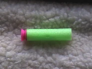 A green and pink Nerf SuperMAXX Dart.