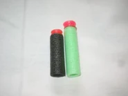 A comparison in length between Larami (black) and Nerf (green) SuperMAXX Darts.