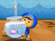 Geo saves the fish.webp (12 KB) Geo holding the fishbowl.