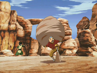 Aang carries a rock