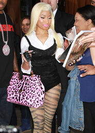 Nicki returns to her hotel signing fans merchandise