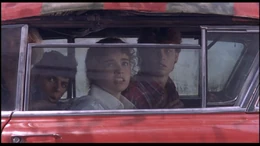 Glen, Nancy, Rod, and Tina, trapped within the car, controlled by Freddy.