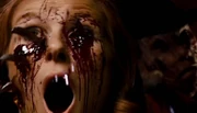 Revealing himself to have survived their fight, Freddy shoves his claws though the back of Gwen's head and gouges her eyes, murdering her in front of Nancy
